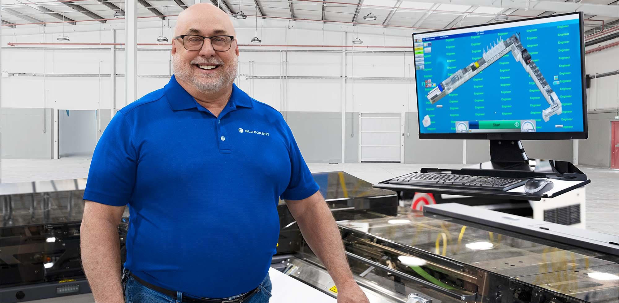 BlueCrest service employee in front of mail inserter
